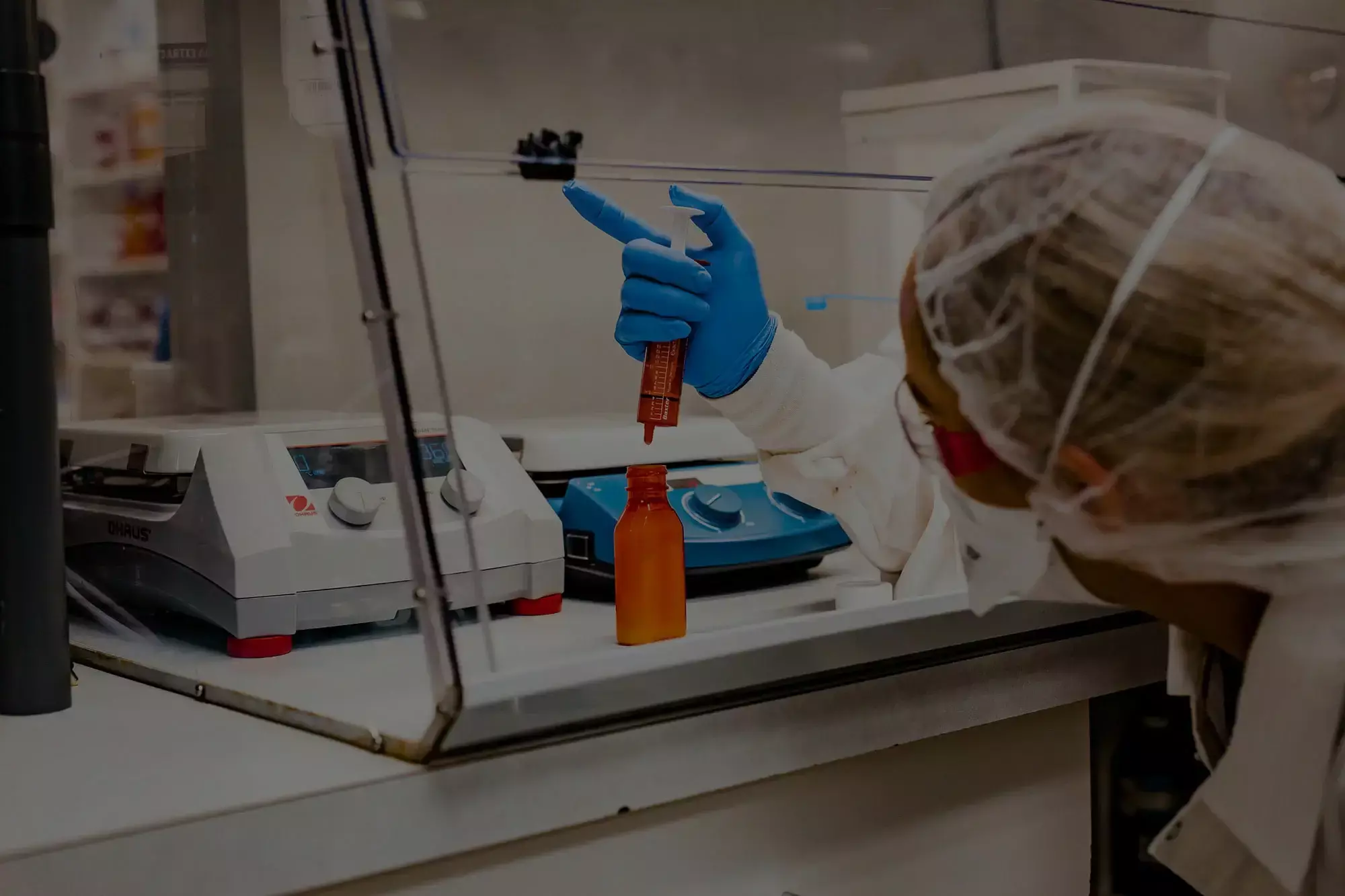 Pharmacist holding a syringe of compounded liquid medication